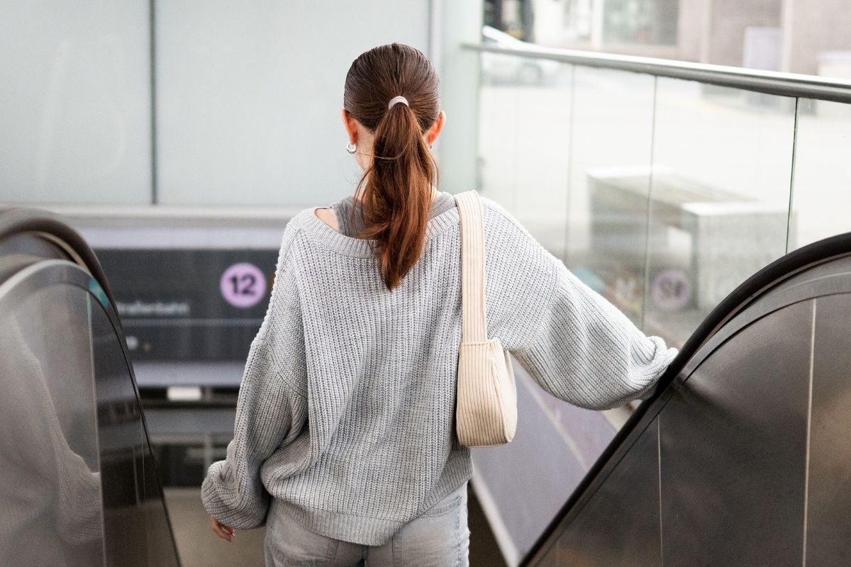woman going down an escalator