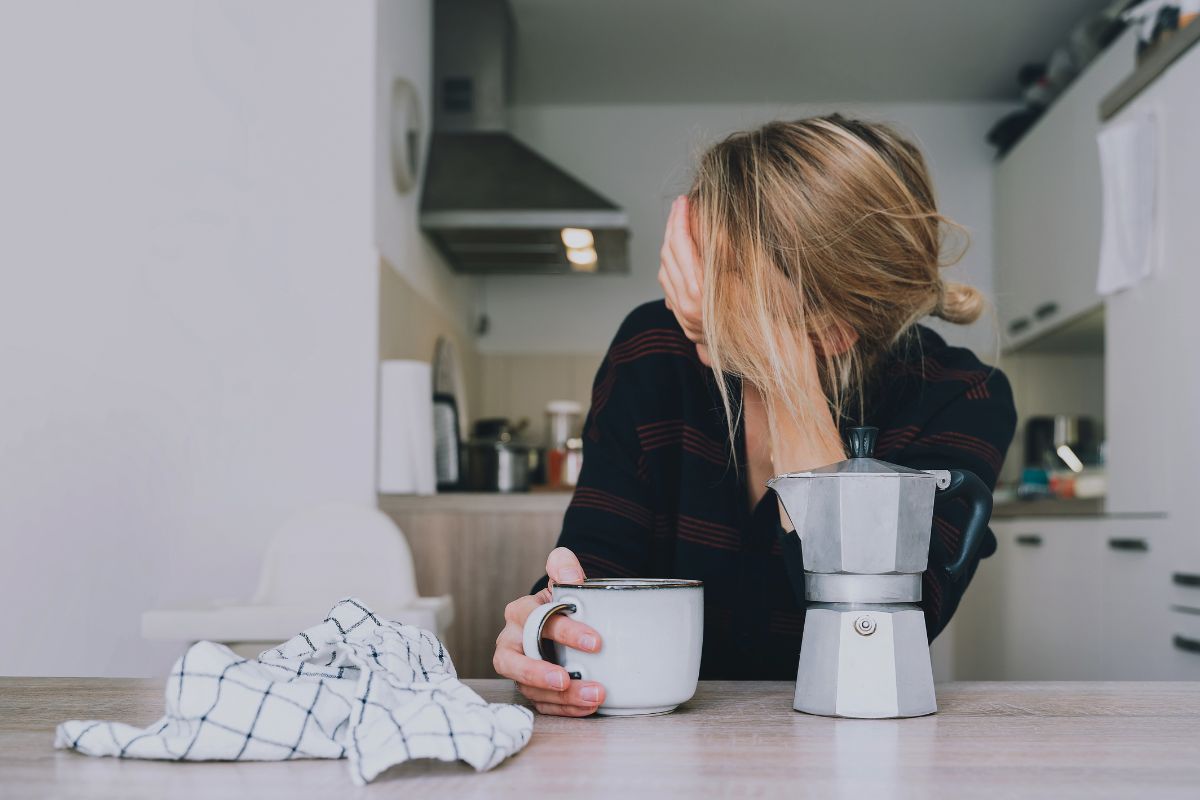 woman looking tired with coffee