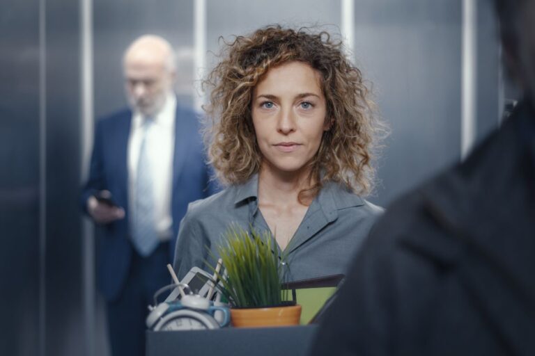Woman holding a box of her stuff from her desk