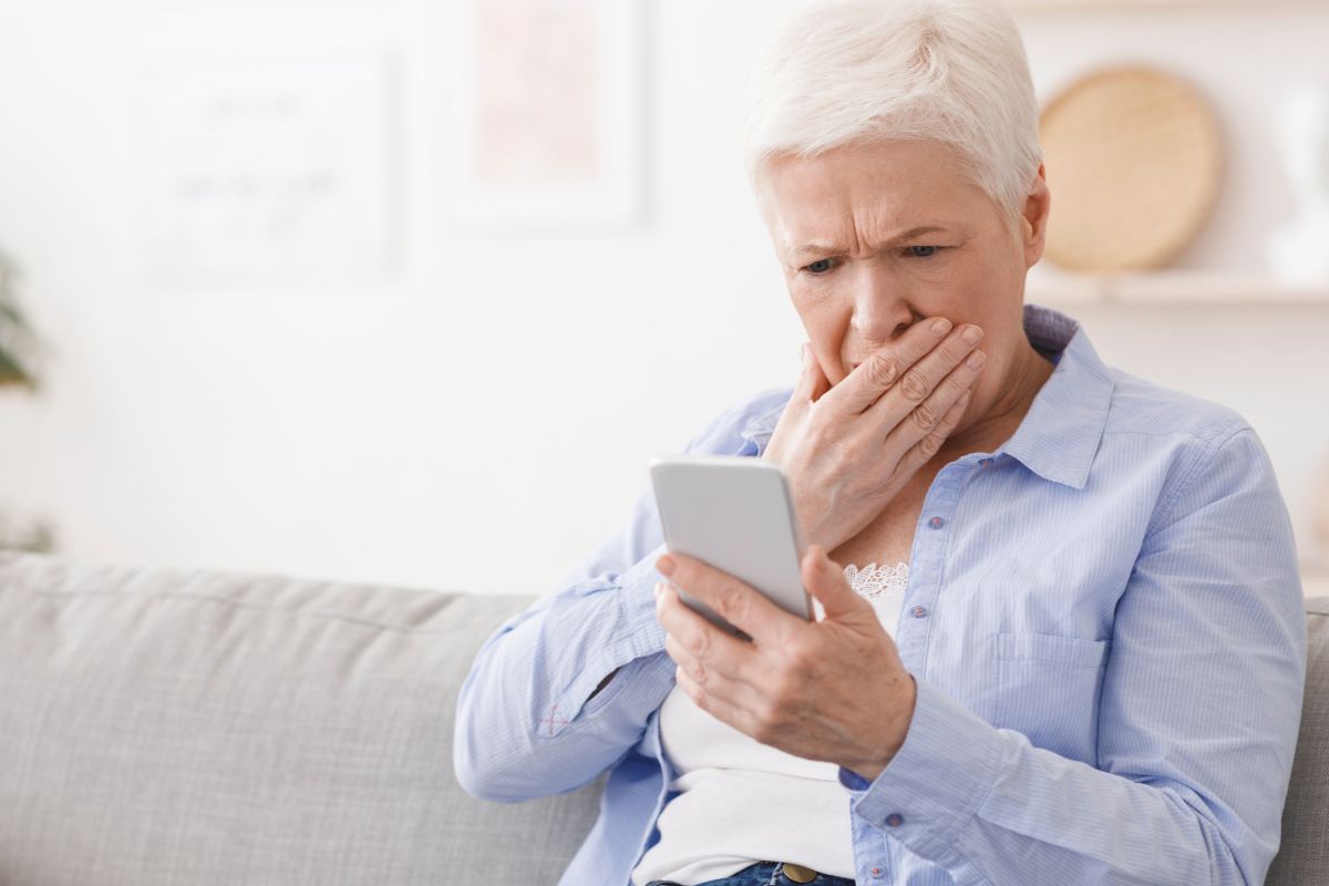 Woman looking worried looking at her phone