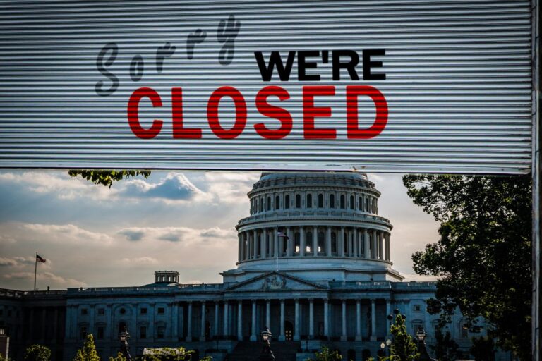 capital building with a sorry we're closed sign