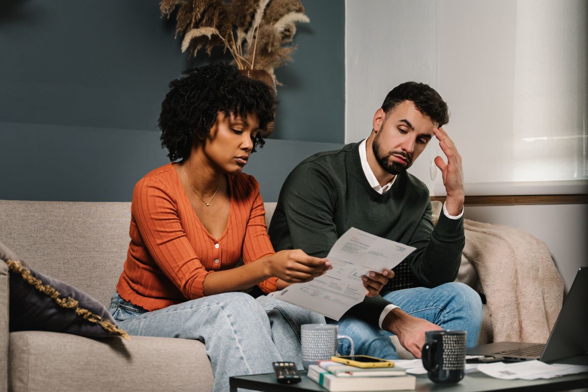 couple on the couch looking stressed