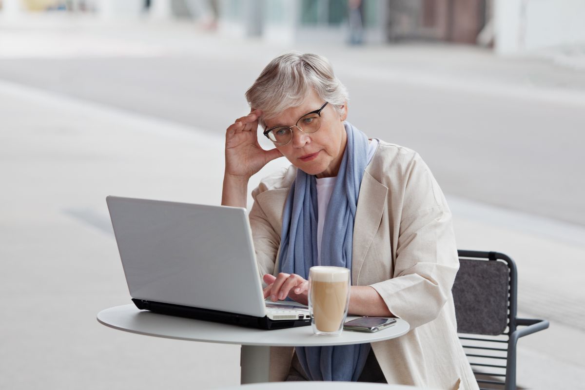senior woman working on a lap top and looking stressed