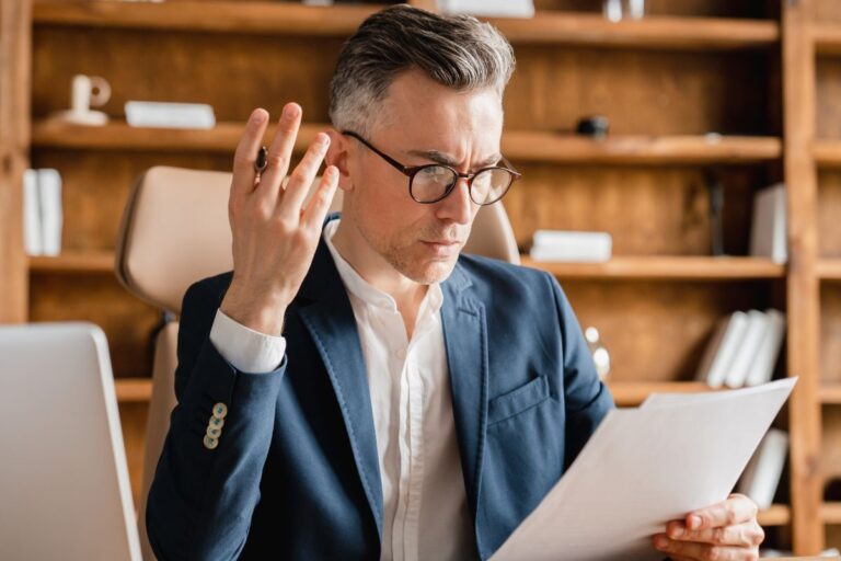 Man looking annoyed at a piece of paper