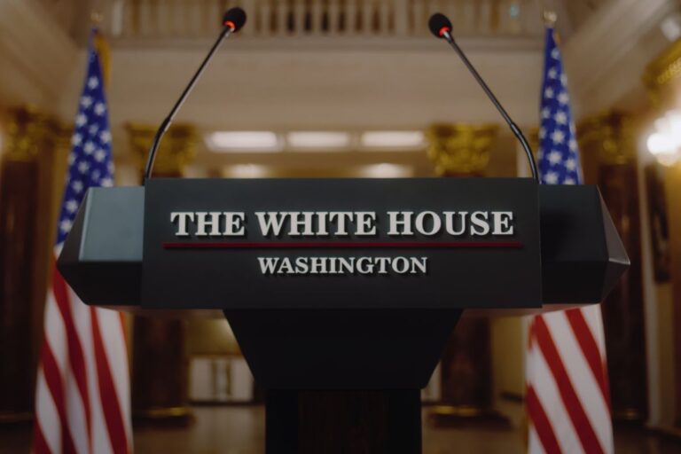 The white house podium with two flags behind it
