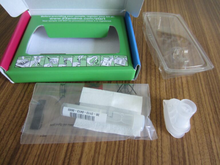 A 23andMe saliva DNA test kit with its collection tube and box