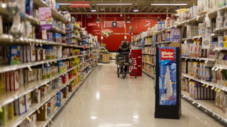 A grocery store aisle lined with shelves of packaged food in Vermont